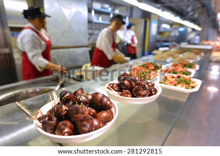 SHANGHAI - MAR 15 2015:Cooked snails on display in a food market in Shanghai China.Chinese cuisine go back for thousands of years, changed according to climate, imperial fashions and local preferences