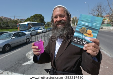JERUSALEM, ISR - MAR 24 2015:Orthodox Jewish man collecting Tzedakah (charity).In Judaism, tzedakah refers to the religious obligation to do what is right and just as parts of living a spiritual life.