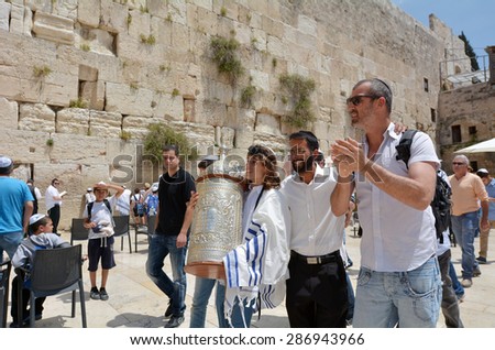 JERUSALEM, ISR - MAY 05 2015:Bar Mitzvah ritual at the Wailing wall in Jerusalem, Israel.Boy who has become a Bar Mitzvah is morally and ethically responsible for his decisions and actions.