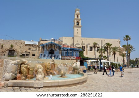 TEL AVIV, ISRAEL - MAR 24 2015:Visitors at the Zodiac Fountain in Kedumim Square in Old Jaffa, Tel Aviv, Israel.The fountain echoes the zodiac theme of Jaffa\'s Old City.