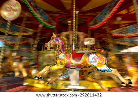 Motion blurr of vintage horse of amusement ride on merry-go-round carousel.  Amusement concept