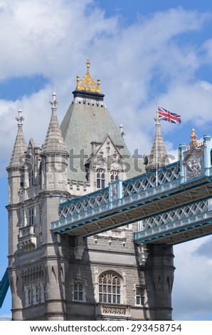 LONDON - MAY 13 2015:Flag of England flying alongside the flag of the United Kingdom on top of the Northern Tower of the Tower Bridge in London, UK.The bridge towers are 213 feet (65 m) high each