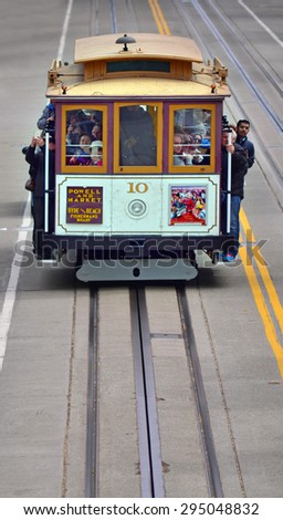 SAN FRANCISCO - MAY 19 2015:Passengers riding on cable car on steep hill in San Francisco, CA.By 1979, the cable car system had become unsafe, and closed for 7 months for urgently needed repairs