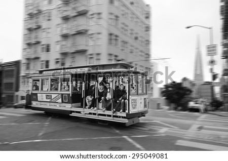 SAN FRANCISCO - MAY 18 2015:Passengers riding on Powell-Hyde line cable car in San Francisco, CA.San Francisco cable car system is the world\'s last manually operated cable car system.