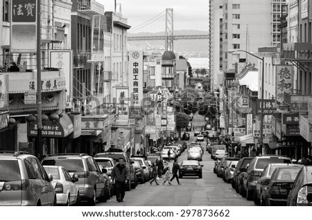 SAN FRANCISCO MAY 19 2015:Chines people and Oakland bay bridge as seen from Chinatown in San Francisco, CA.It\'s the oldest Chinatown in North America and the largest Chinese community outside Asia.