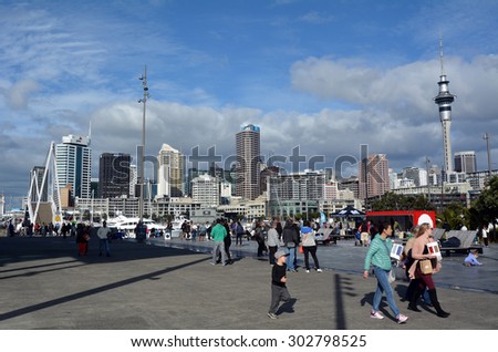 AUCKLAND - AUG 01 2015:Visitors walks at Wynyard Quarter against  Auckland skyline New Zealand. Auckland is one of the most ethnically diverse cities in the world.