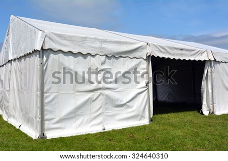 Empty event tent in a fair outdoor on green grass under blue sky. concept