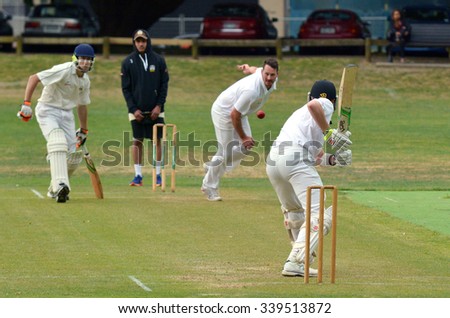 AUCKLAND - NOV 14 2015:Men play Cricket in victoria park Auckland, New Zealand.Cricket is played by 120 million players in many countries, making it the world\'s 2nd most popular sport.