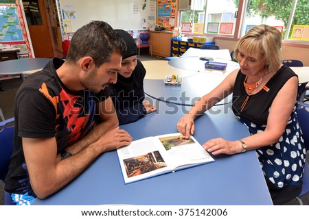 AUCKLAND - FEB 21 2016:Auckland University of Technology teacher teaches Syrian refugee English at Mangere Refugee Resettlement Centre.New Zealand annual intake is 750 refugee fleeing war in Syria.