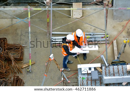 Aerial view of two unrecognized civil engineers inspecting construction site. Building development concept.
