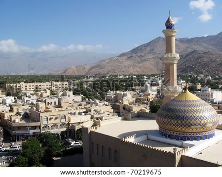Urban view of Nizwa and a mosque, from Nizwa Fort lookout in the Sultanate of Oman in the Middle East.