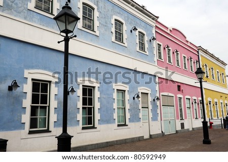 A Photograph of Portuguese Buildings. Bright and contrasting colors.
