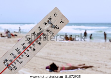 A temperature scale on a beach shows high temperatures during a heat wave.