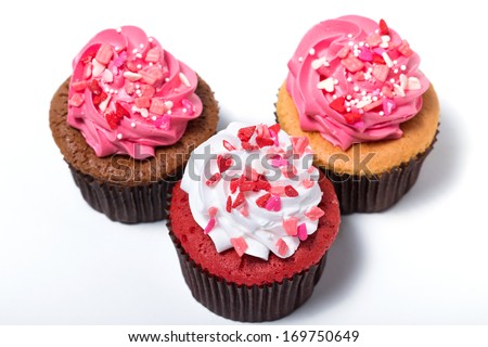 Three sweet cupcakes. Isolated on white background.