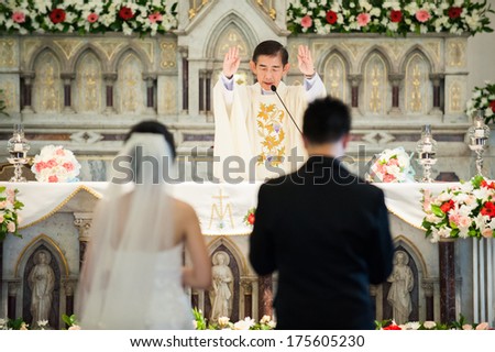 BANGKOK - 16 SEP : Engagement Ceremony in Kallawha Church, Christ culture. Father pray for bride and groom. On SEPTEMBER 16, 2012 in Bangkok, Thailand