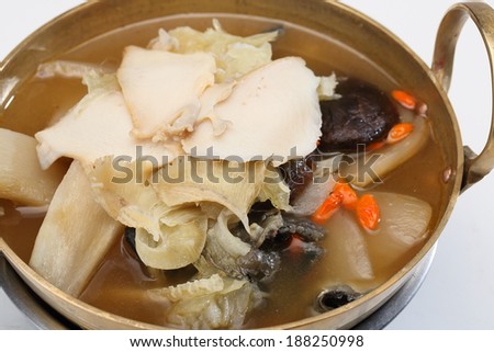 Shark fin soup in metal bowl