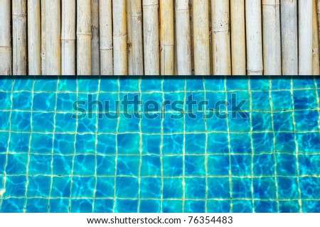 A bamboo floor next to a pool
