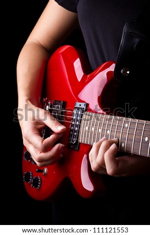 Closeup view of playing electric red guitar
