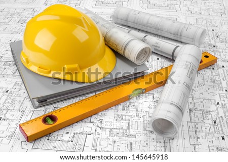Yellow helmet, level, grey folder document and project drawings
