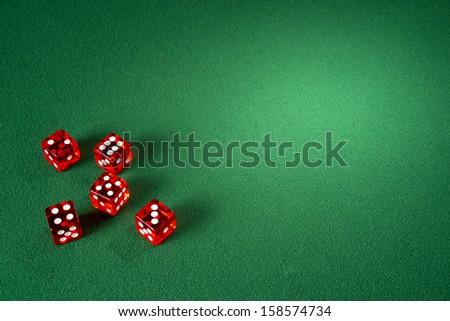 Red dice on a green felt