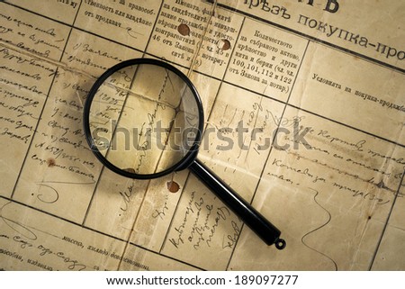old deed property and magnifying glass, selective focus