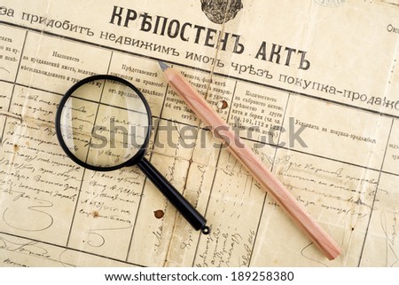 old deed property, magnifying glass and pencil, selective focus