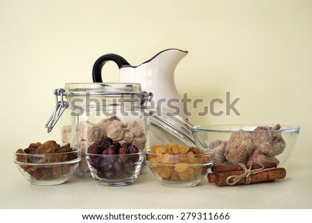 raisins, figs, dry briars, cinnamon and brown sugar over yellow background