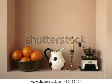 Oranges and household items in a niche