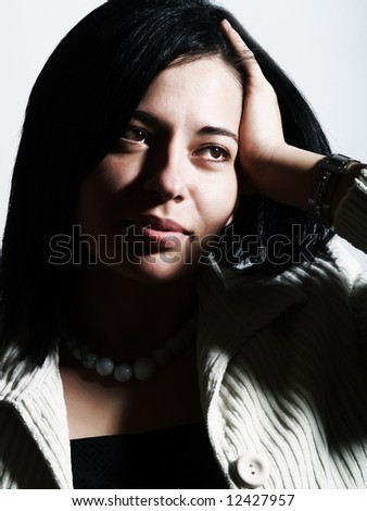 A high-key portrait about an attractive lady with black hair who is looking at something, she is wishing something and she has a charming look.