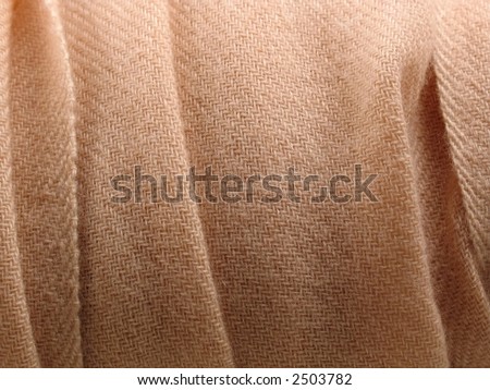 Folds of a pale pink soft woolen pashmina scarf