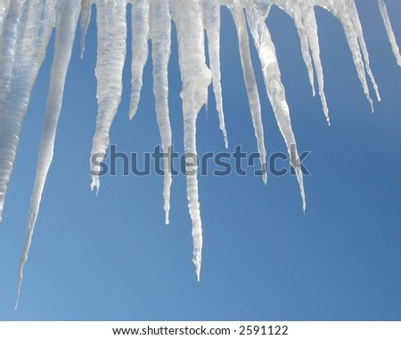 White icicles drop from a blue sky.