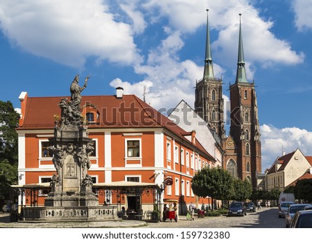 WROCLAW, POLAND - AUGUST 2013: Monument to John of Nepomuk and the Cathedral of St. John the Baptist on the island Tumskoe on august 05, 2013 in Wroclaw