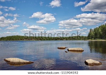 Stones on a  lake surface. A lake on Suna river, Karelia, Russia.