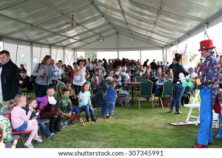BARLOW, DERBYSHIRE, UK. AUGUST 15, 2015.  The showground beer tent with children\'s entertainer at the village carnival at Barlow in Derbyshire, UK.