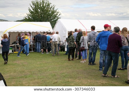 BARLOW, DERBYSHIRE, UK. AUGUST 15, 2015.  The queue for burgers on the showground of the village carnival at Barlow in Derbyshire, UK.