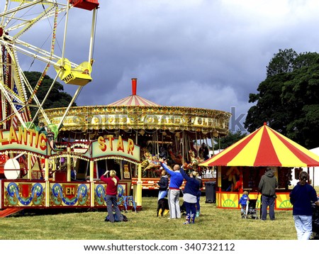 MOORGREEN, NOTTINGHAMSHIRE, UK. AUGUST 29, 2011.   Families enjoy all the fun of the fair at the Moorgreen Country show in Nottinghamshire, UK.