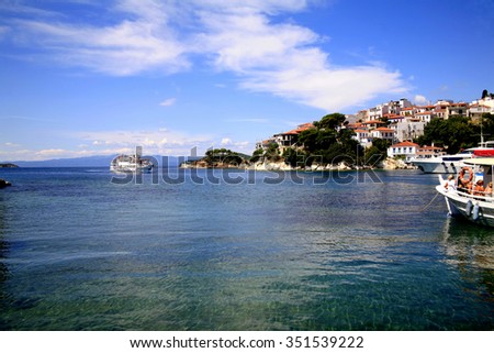 SKIATHOS, GREECE - JUNE 20, 2014. A crowded pleasure cruise boat arriving at the old port at Skiathos town on the Island of Skiathos in the Greek Islands, Greece.