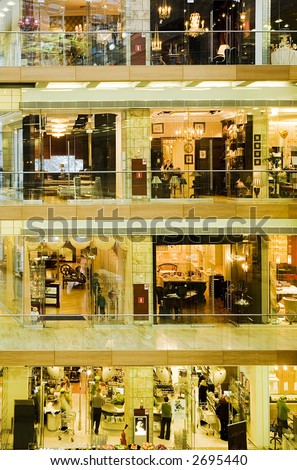 Show-windows of shops located on different floors in a mall