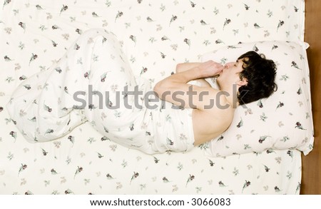 sleeping man with a finger in a mouth (from above)