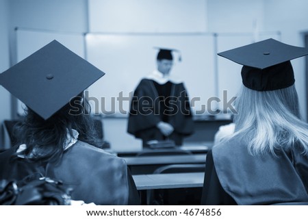 students and professor in gowns