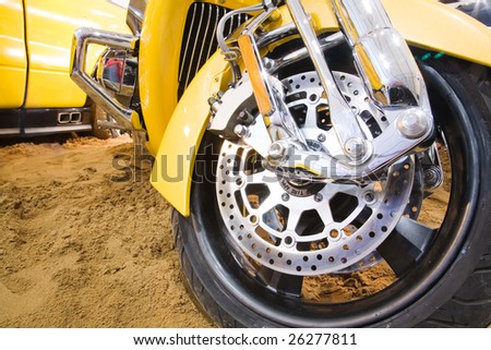 wheel of excellent yellow motorbike on the sand