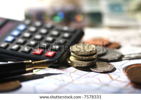 coin, pen, calculator and london underground map
