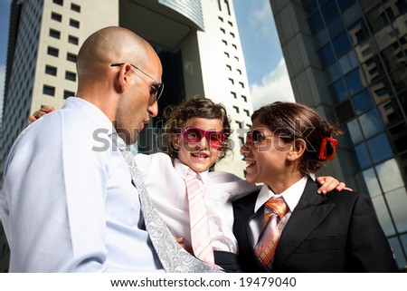 Portrait of successful family businesspeople near a office building having fun