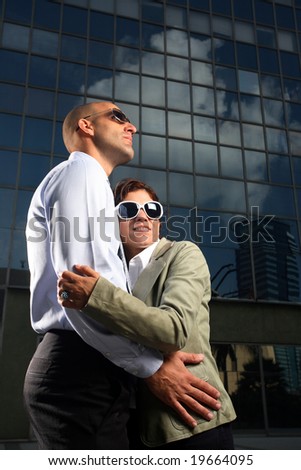 Portrait of a businessman and woman who lost money in stocks over office building