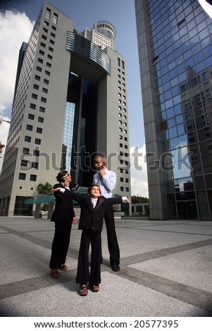 Portrait of successful family businesspeople near a office building having fun