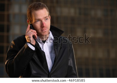 A young businessman outside of building looking depressed after being fired