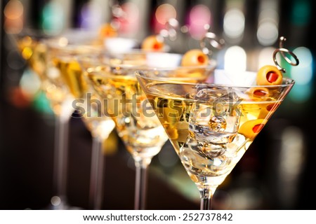 Several glasses of famous cocktail Martini, shot at a bar with shallow depth of field