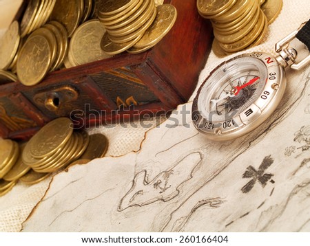 Treasure chest with gold coins, treasure map and compass