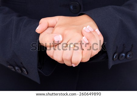 Public speaker in a dark costume, making hand gesture for better speaking