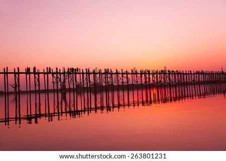 U Bein Bridge at sunset with people crossing Ayeyarwady River, Mandalay, Myanmar